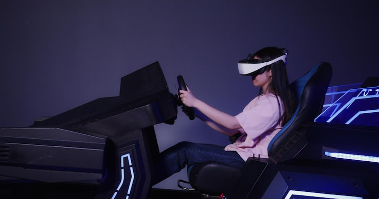 Person using a VR racing simulator with steering wheel and motion rig